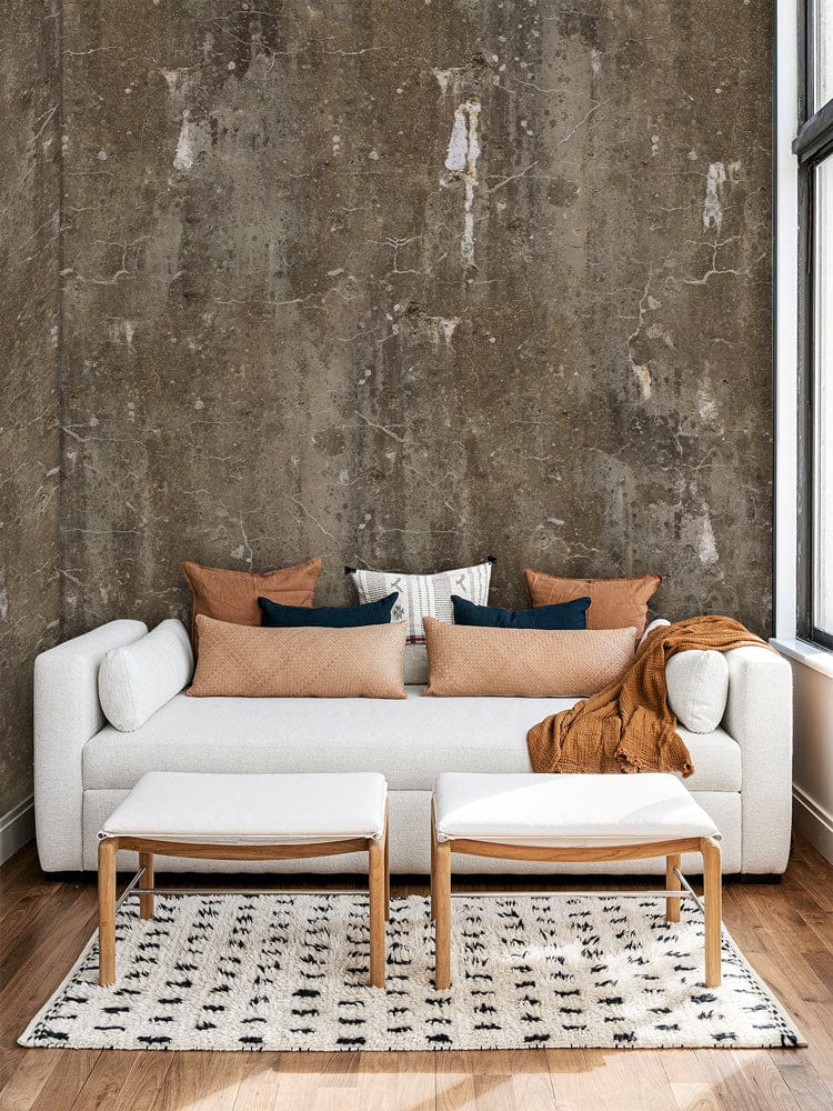 Photo d’un lit de jour blanc moderne avec coussins, avec un papier peint mural à motifs sombres mouchetés