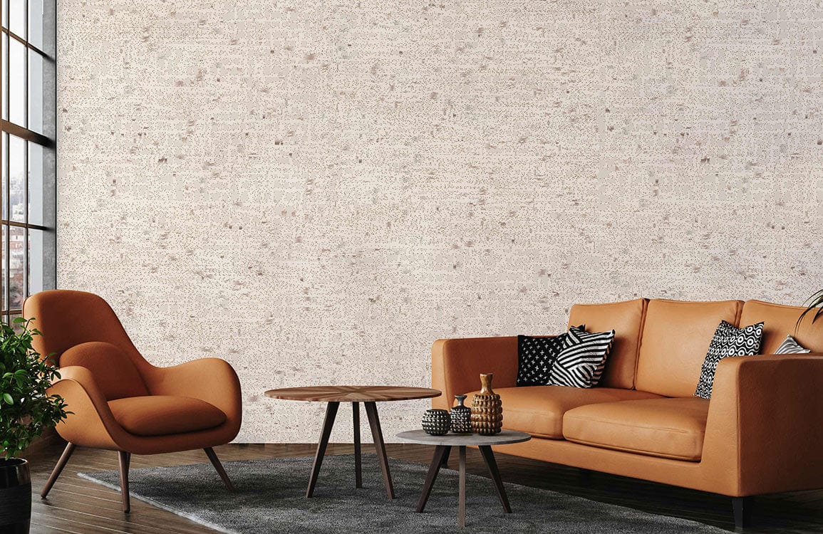 Papier peint mural à texture de points dans un salon moderne avec canapé en cuir tan et fauteuil orange