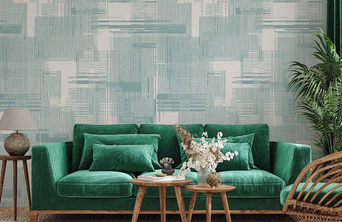 Sofa en velours vert teal avec coussins assortis, idéal pour un papier peint mural à texture vague