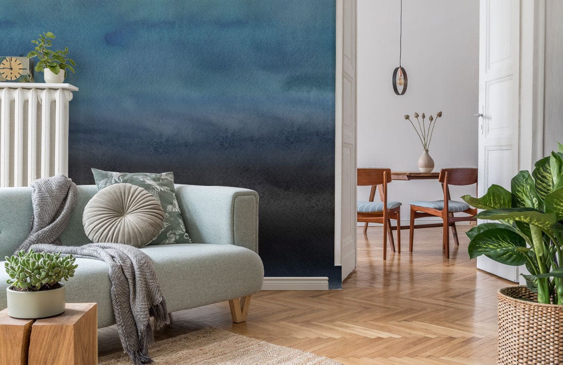 Canapé deux places bleu clair avec coussins et plaid gris, idéal pour peinture murale unique