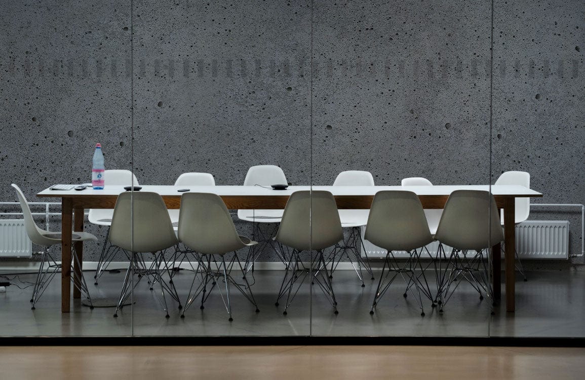 Papier peint mural en ciment marbré avec table moderne et chaises blanches