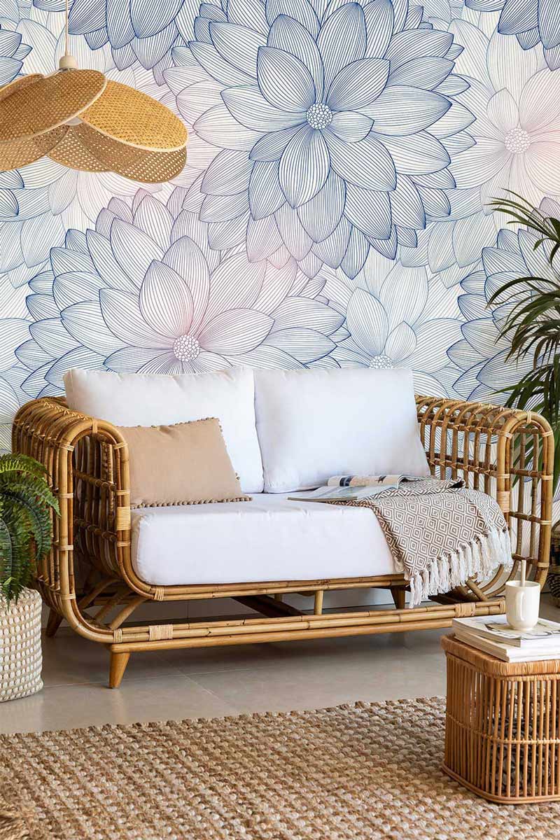 Canapé en rotin deux places avec coussins blancs, idéal pour un papier peint mural fleurs